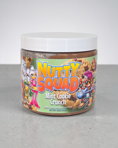 Jar of 'Nutty Squad Mint Cookie Crunch' peanut butter with colorful label on a gray surface.
